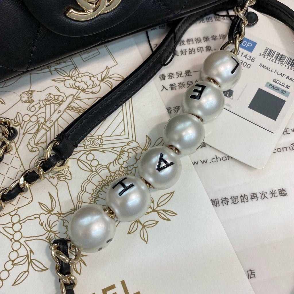 Chanel Pearl Logo Strap Flap Bag Black